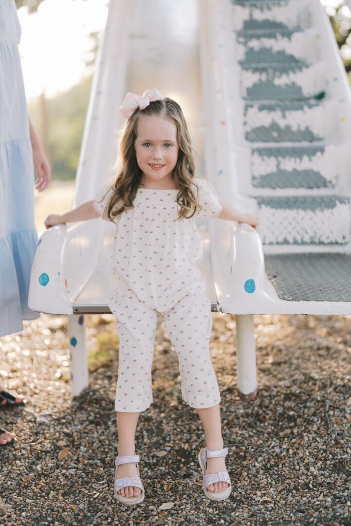 little girl at the bottom of a slide