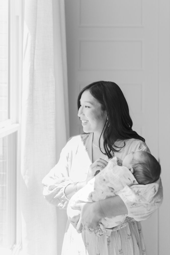 mom with infant snuggled close to face by Newborn Photographers Colorado Springs