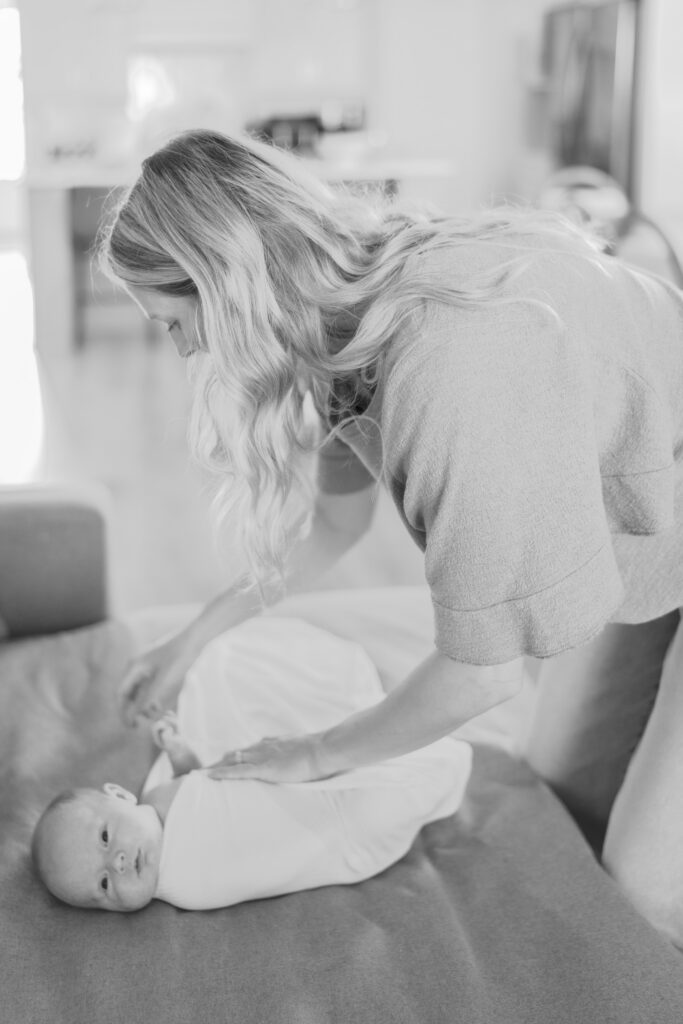 mom swaddling baby for colorado springs lifestyle newborn photos