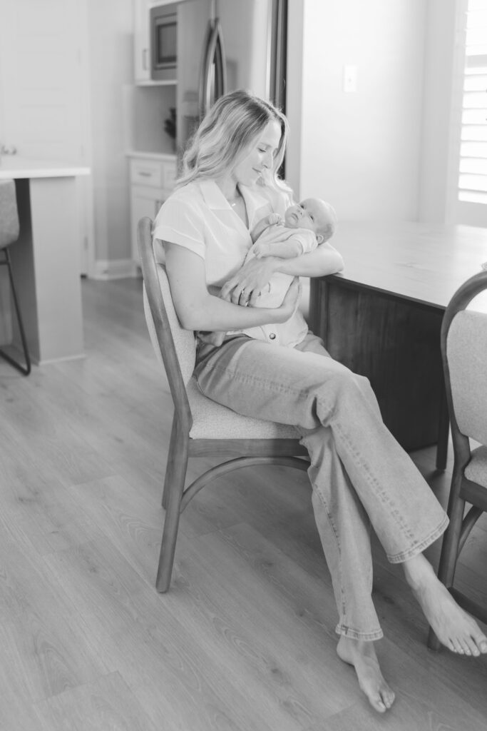 mom holding baby at kitchen table