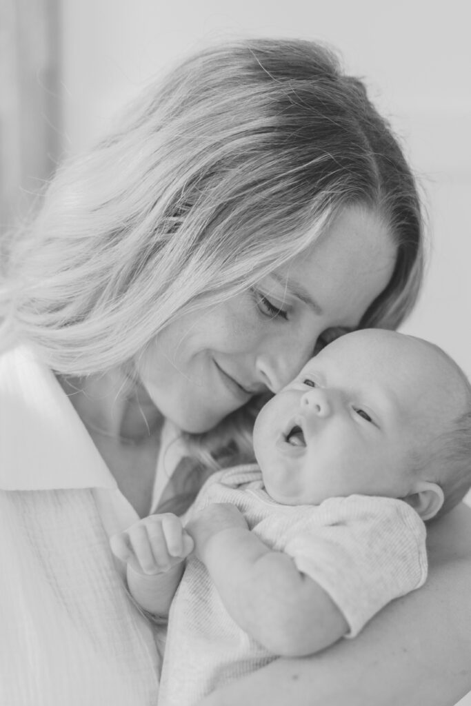 mom and newborn smiling