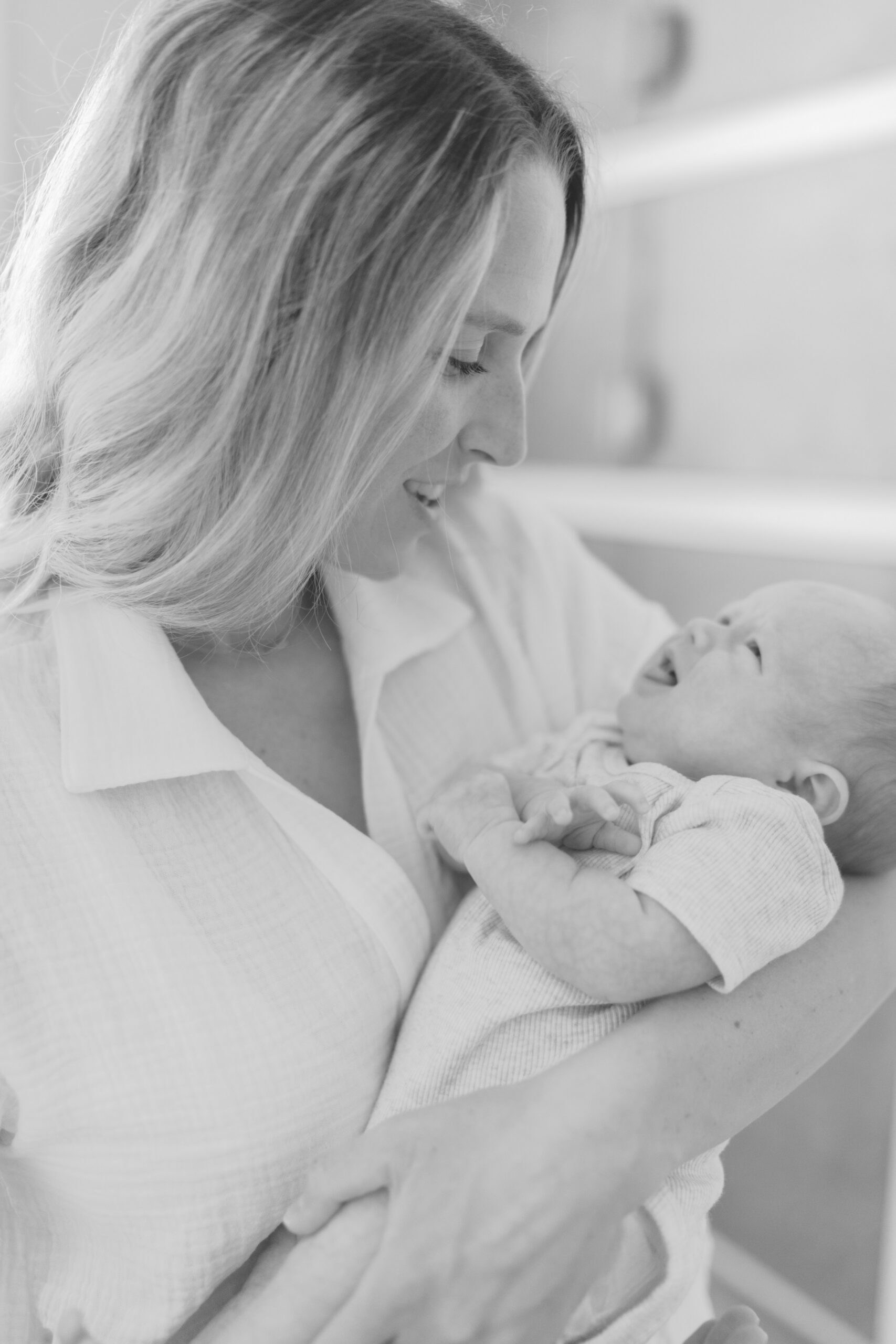 mom holding newborn by Colorado Springs Lifestyle Photographer Lauren Bounds