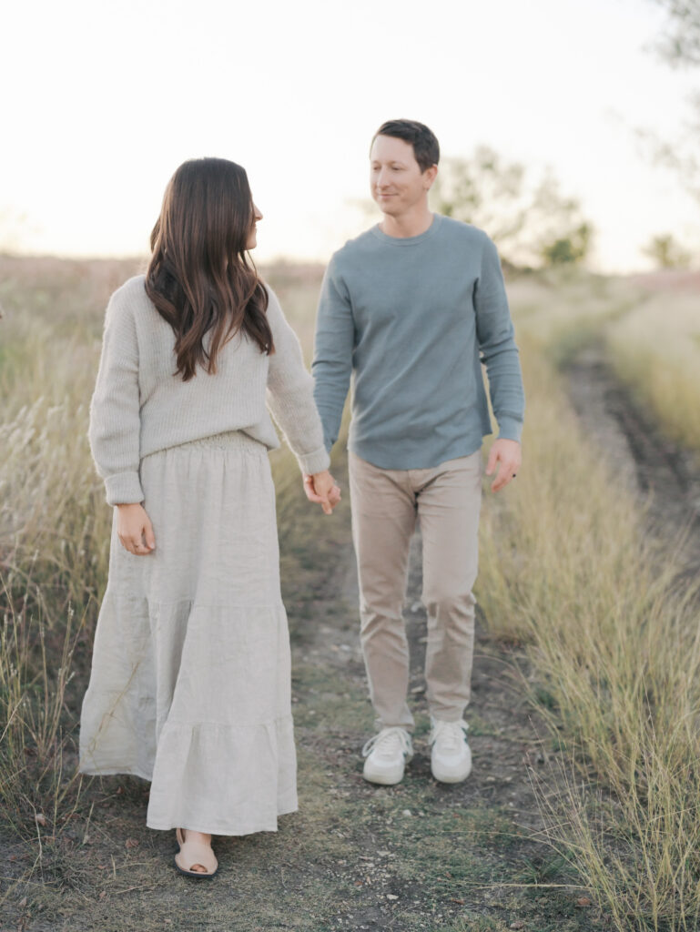 wife looking back at husband while holding hands
