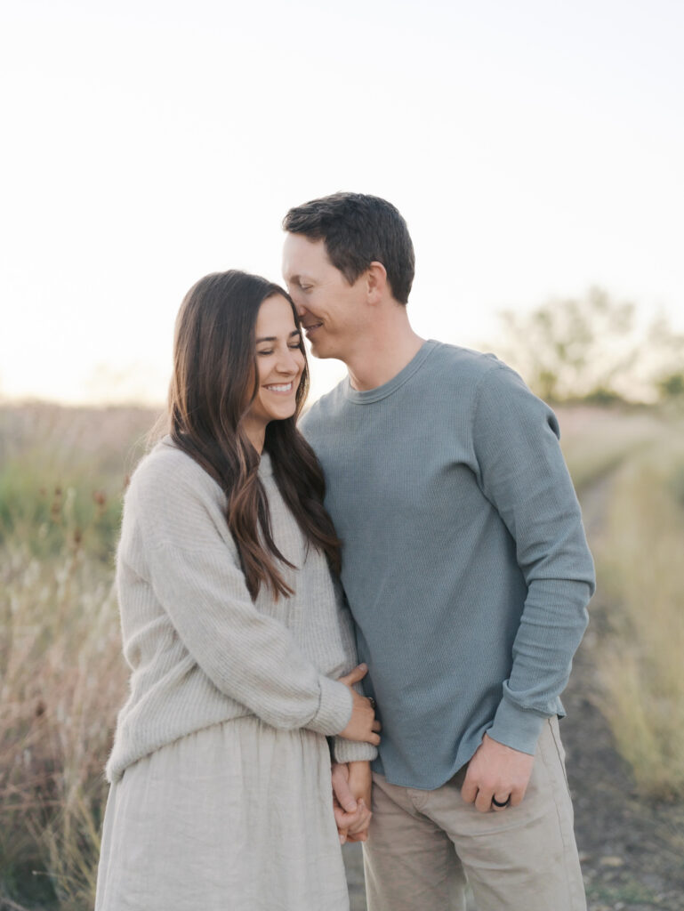 husband nuzzling wife and smiling for colorado springs family session with Lauren Bounds Photography