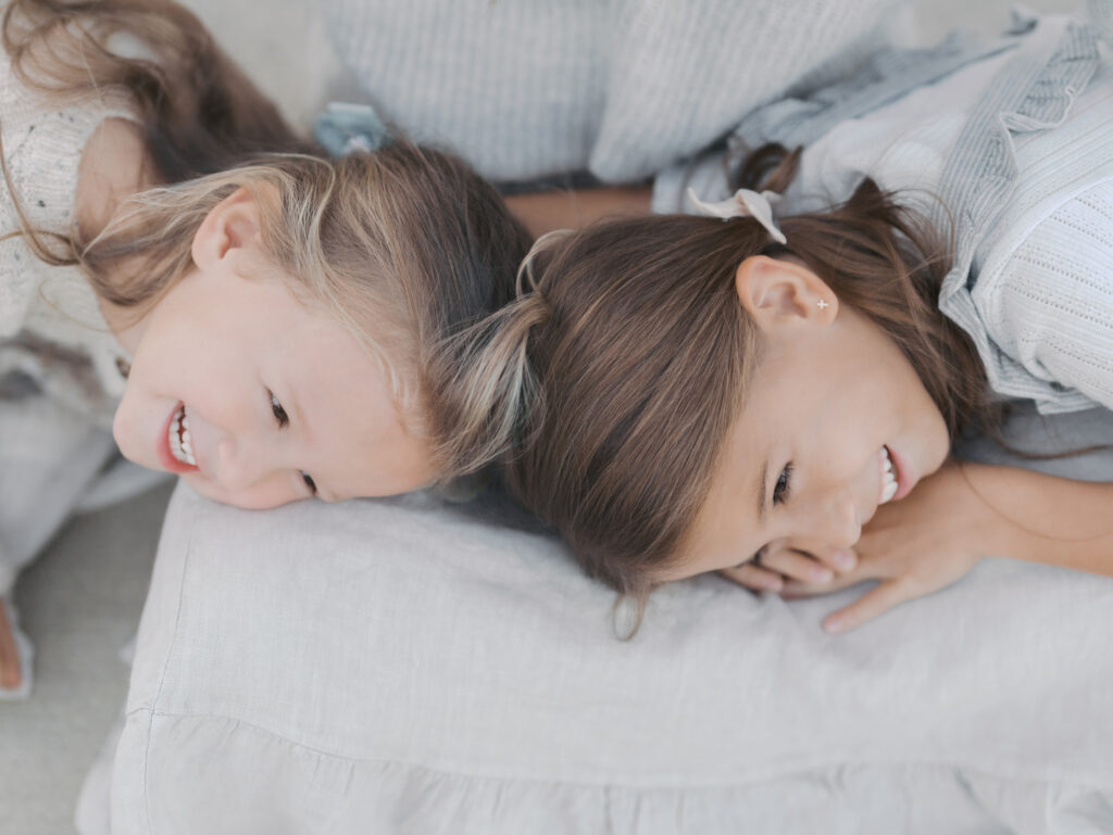 daughters heads laying in moms lap taken at a Colorado Springs family session by Lauren Bounds Photography