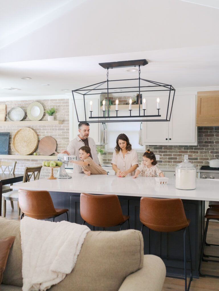 family of four in kitchen making pasta
