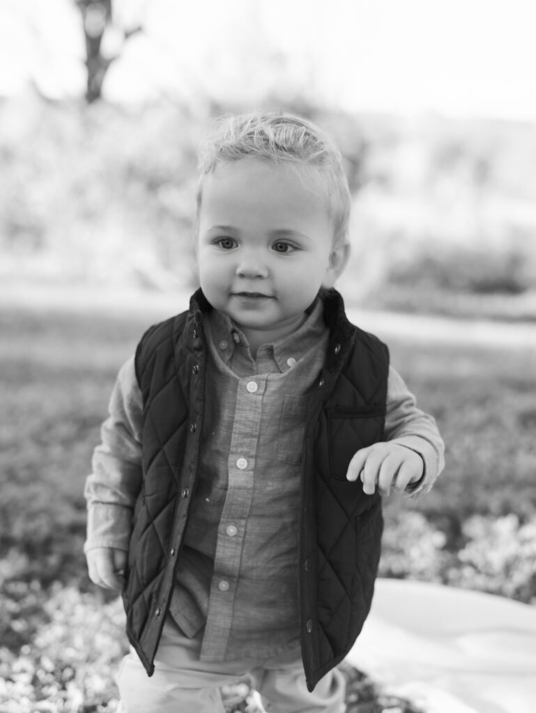 toddler walking while wearing vest