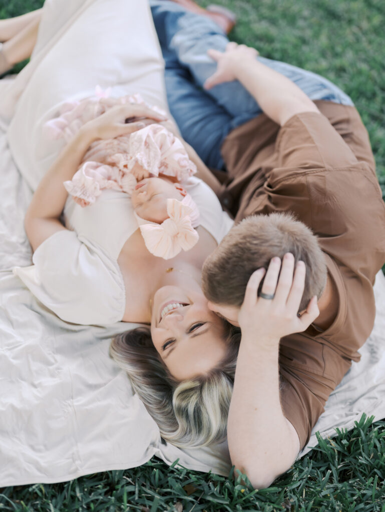 Colorado Springs Outdoor Newborn Session parents laying in grass with newborn