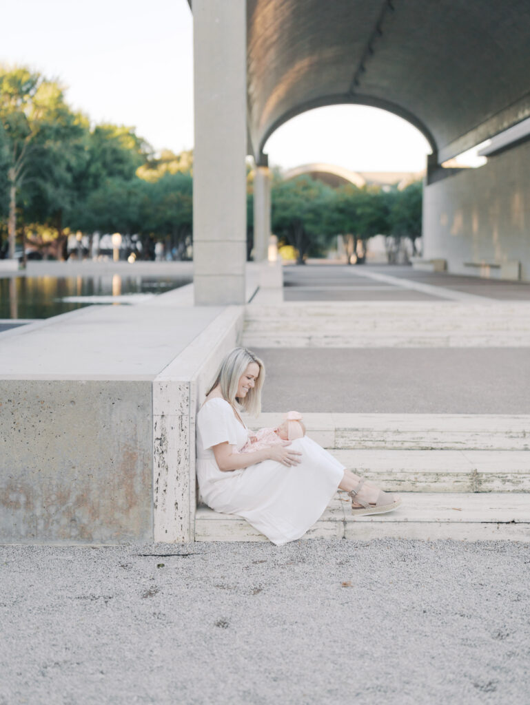 mom sitting on steps with newborn in colorado springs, co