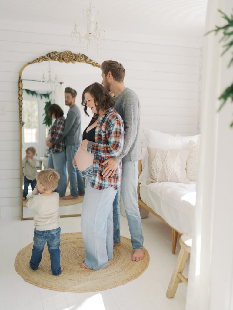 couple in front of mirror with young child for Maternity Photography Colorado Springs