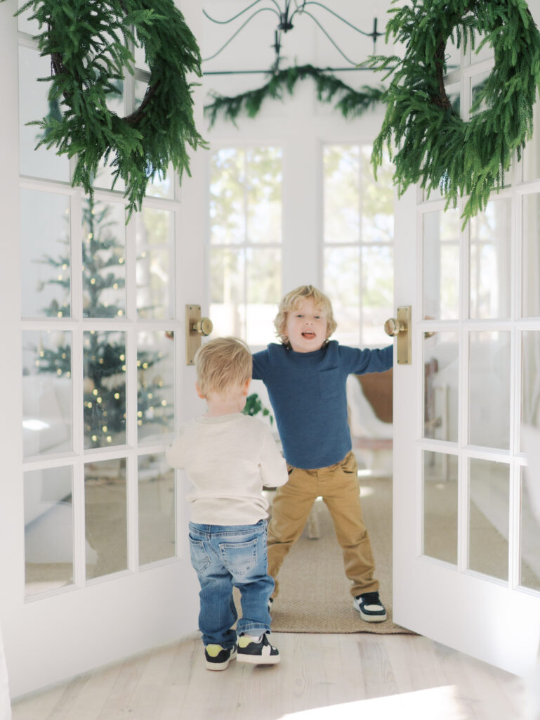 little boys playing while opening double doors