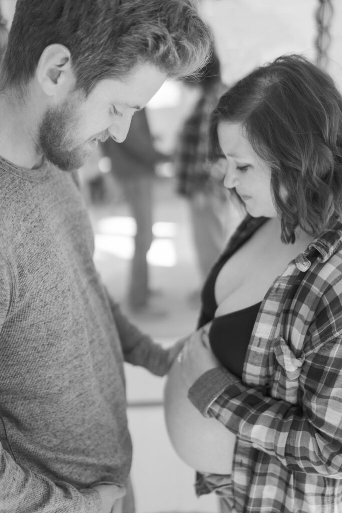 parents gazing at expecting belly head to head 