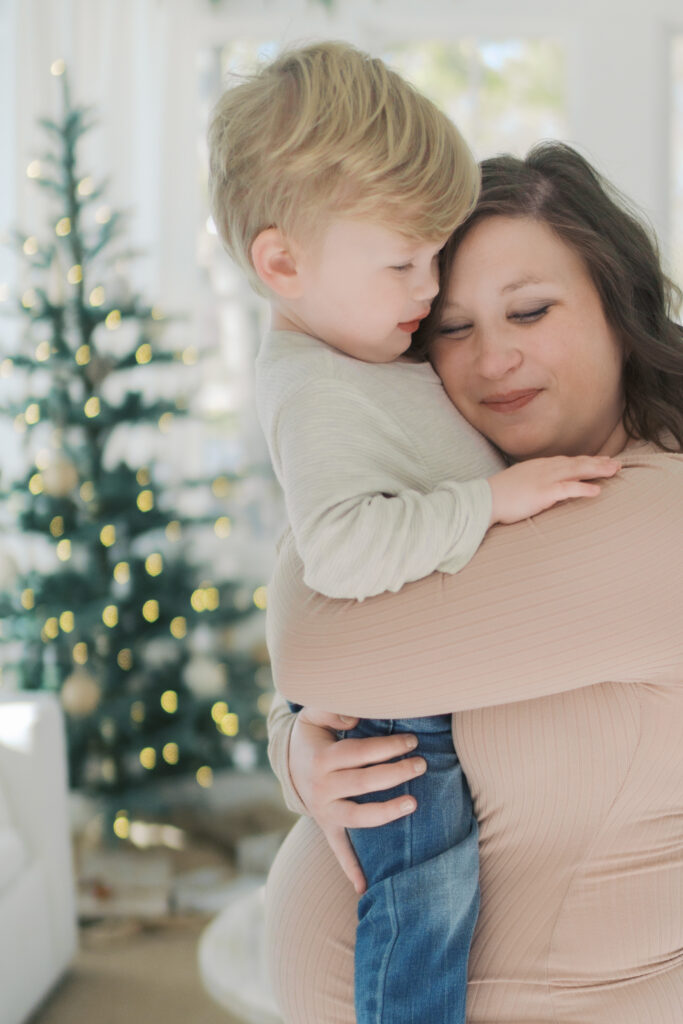 mom hugging little boy in arms