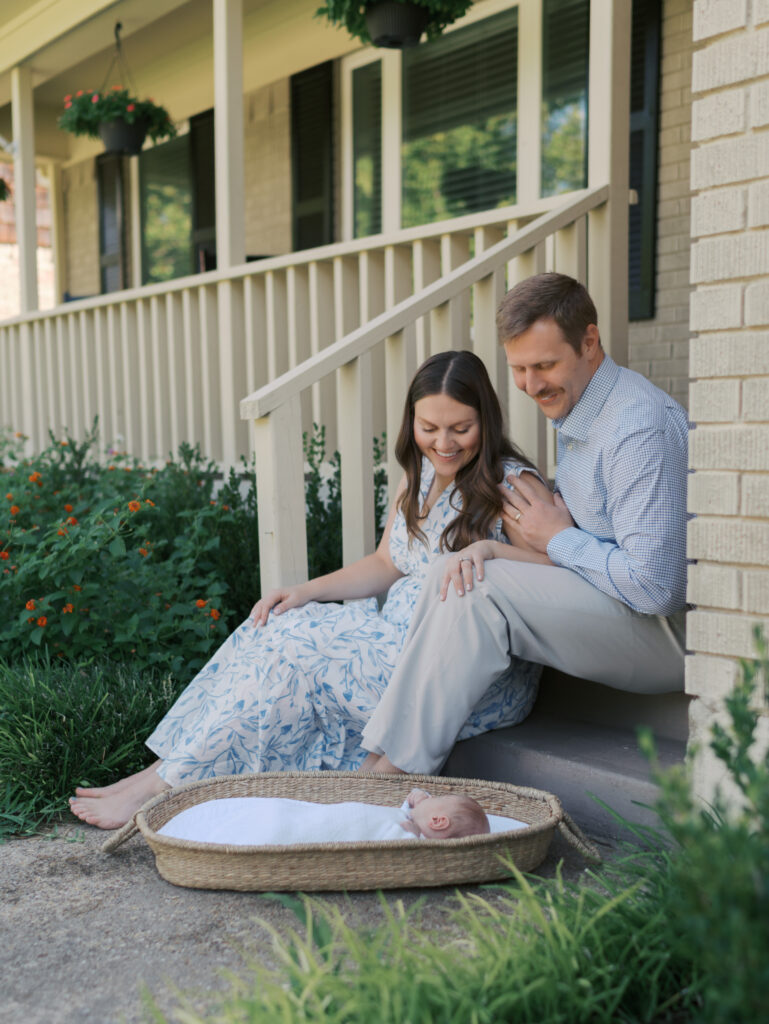 mom and dad on porch with newborn for colorado springs newborn session