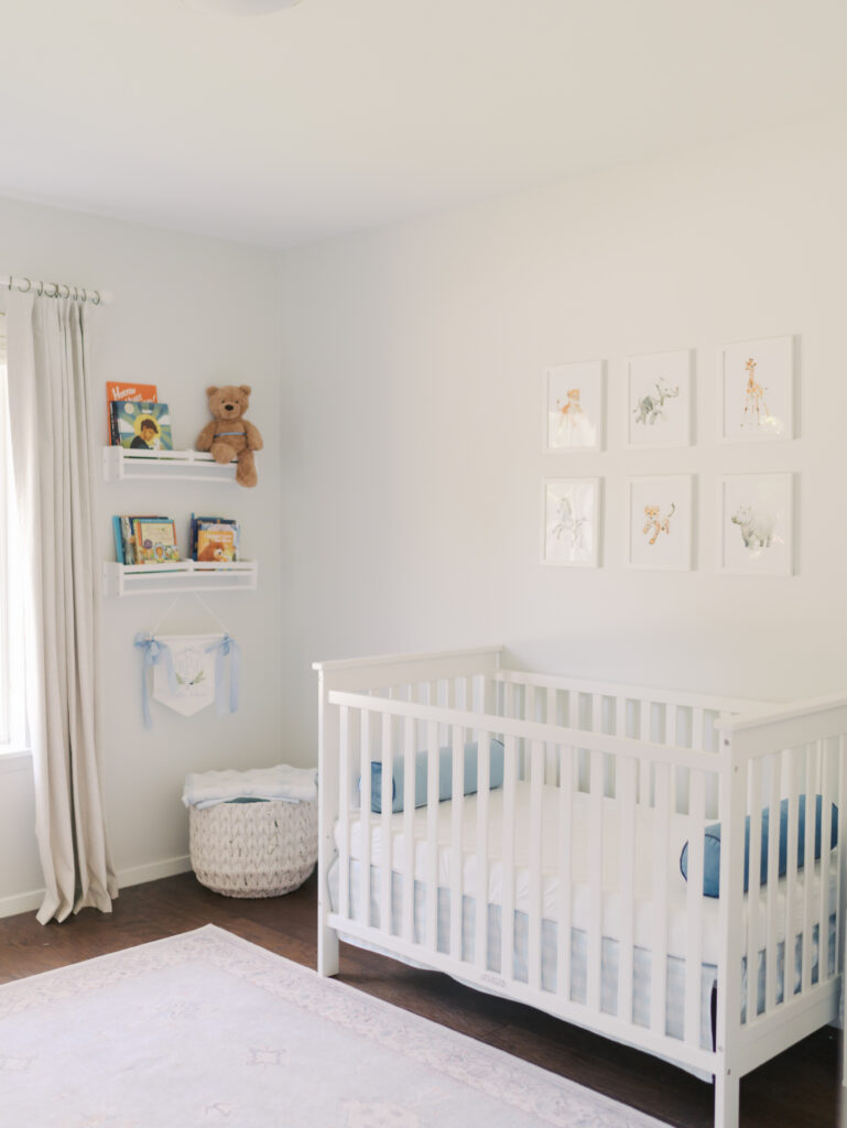 crib in newborn's nursery with book wall