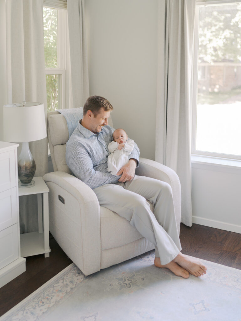 dad with newborn snuggled in arms for Colorado Springs, CO newborn session