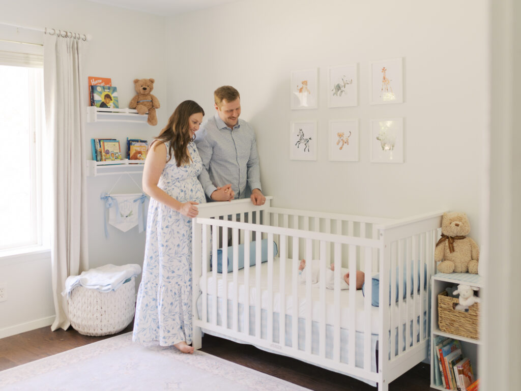 Colorado Springs Newborn Session parents next to crib looking at baby
