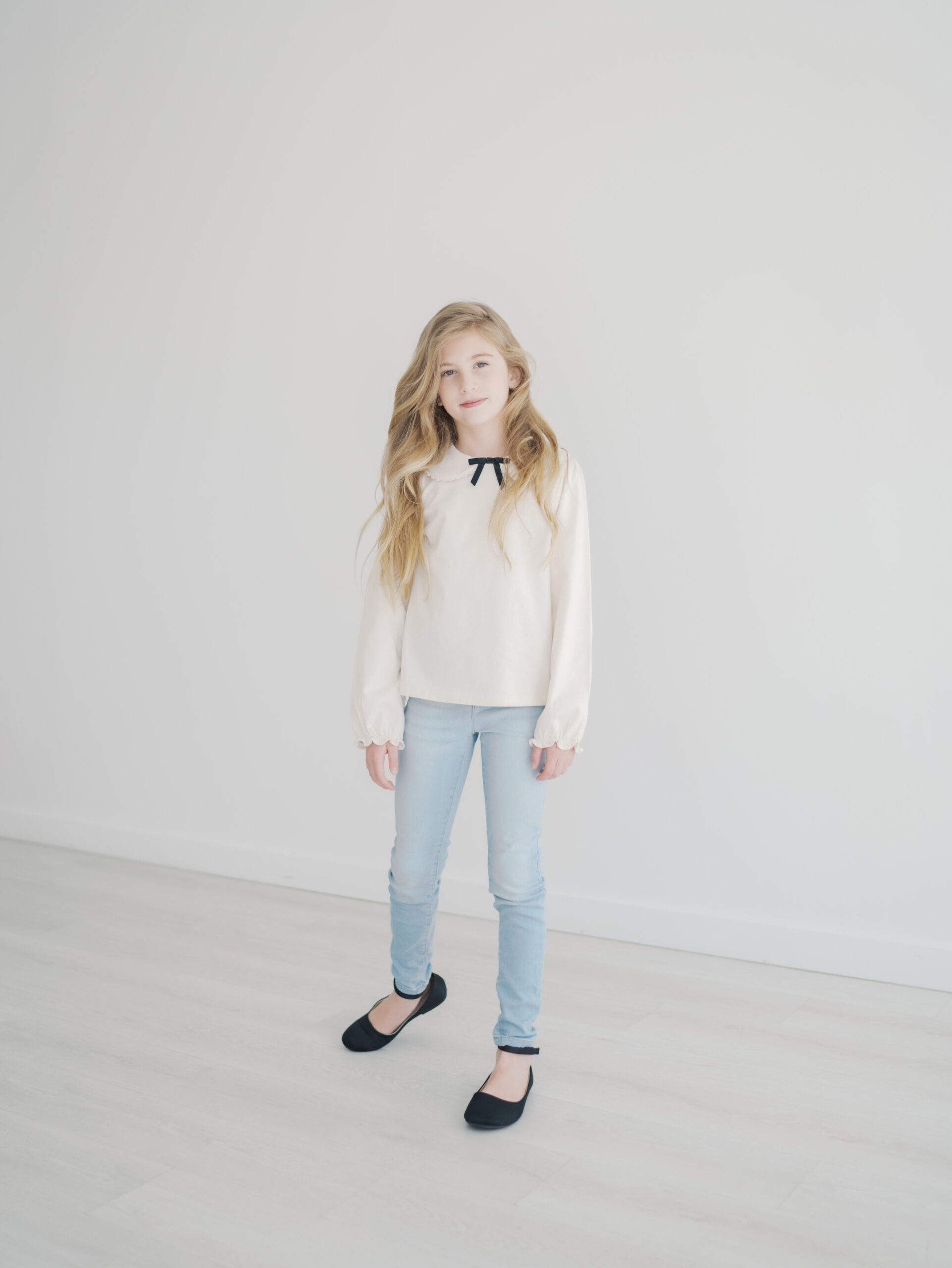 girl in studio standing for kid personality mini session in Colorado Springs