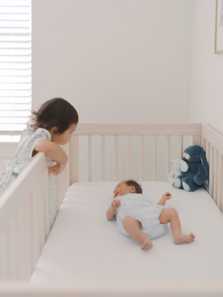 Toddler looking over crib taken by Newborn Photographer Colorado Springs