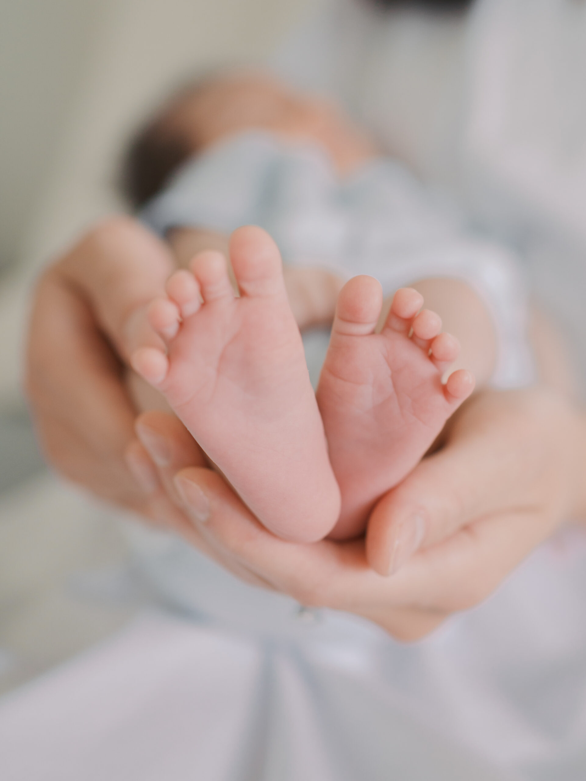 infant feet in dads hands