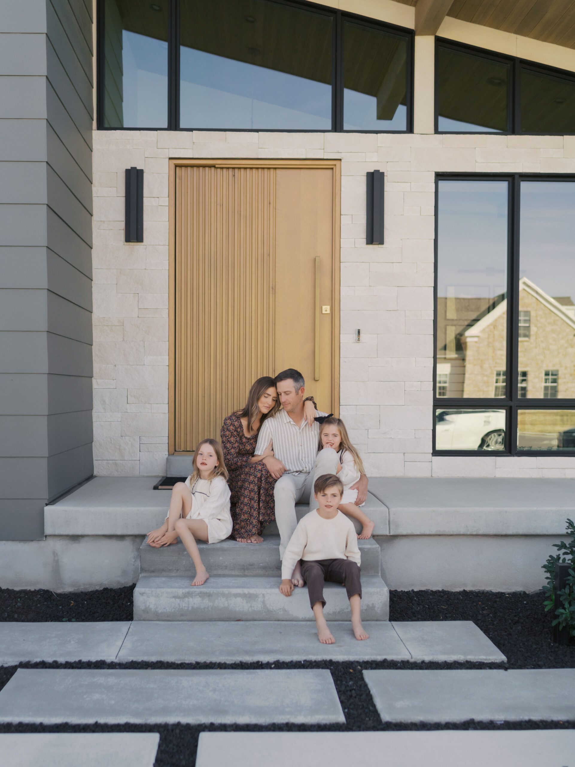 Colorado Springs Family Activities family of five sitting on front porch snuggling