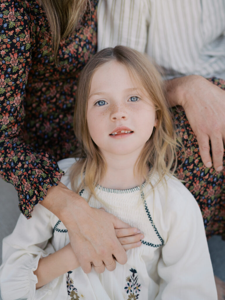 girl leaning against parents for Colorado Springs Family Activities | Lauren Bounds Photography