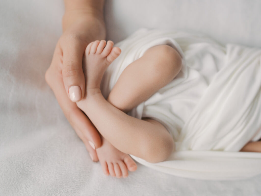 newborn feet in palm of mom's hand | Colorado Springs Newborn Photography | Lauren Bounds Photography
