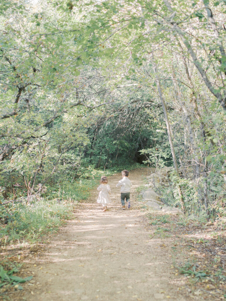 toddlers running in scenic Bear Creek Nature Center at Colorado Springs Family Photo session 