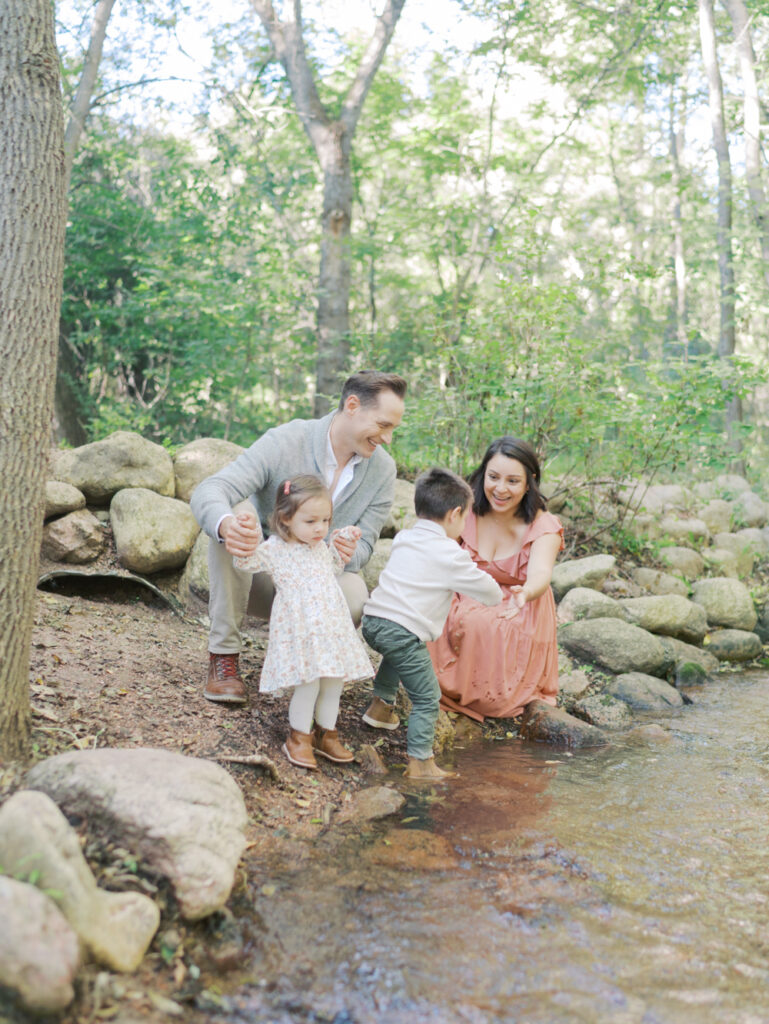 family interacting by bear creek stream taken at Colorado Springs Family Photo session at Bear Creek Nature Center by Lauren Bounds Photography