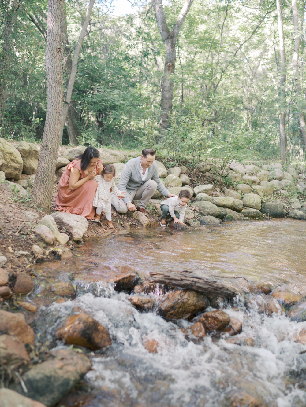 Family playing near creek at Bear Creek Nature Center during a Colorado Springs Family Photo session