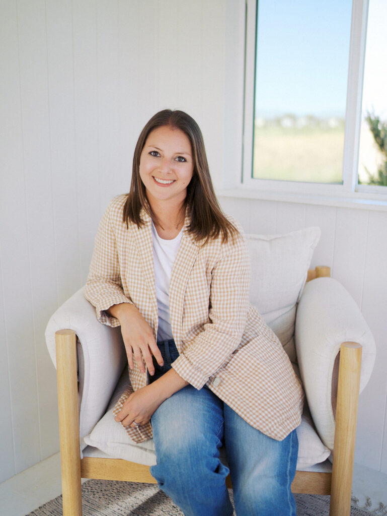 Lauren Bounds headshot sitting in a chair- Colorado Springs Maternity Photographer