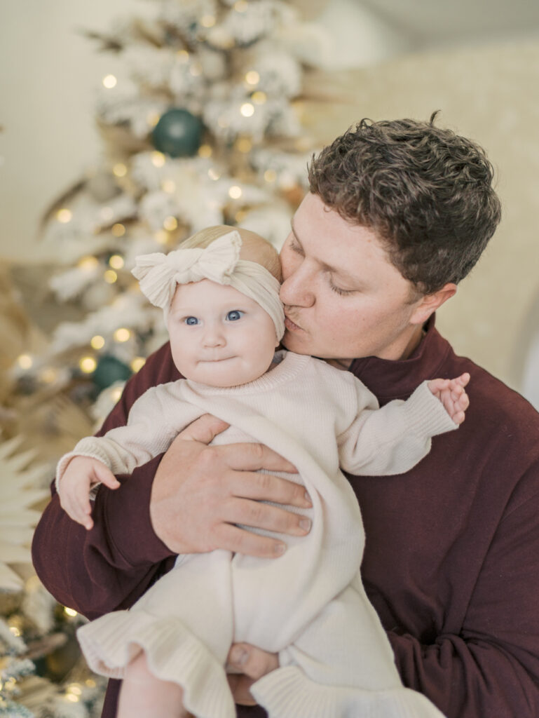 dad kissing baby's cheek at photo studio in Colorado Springs by lauren bounds photography