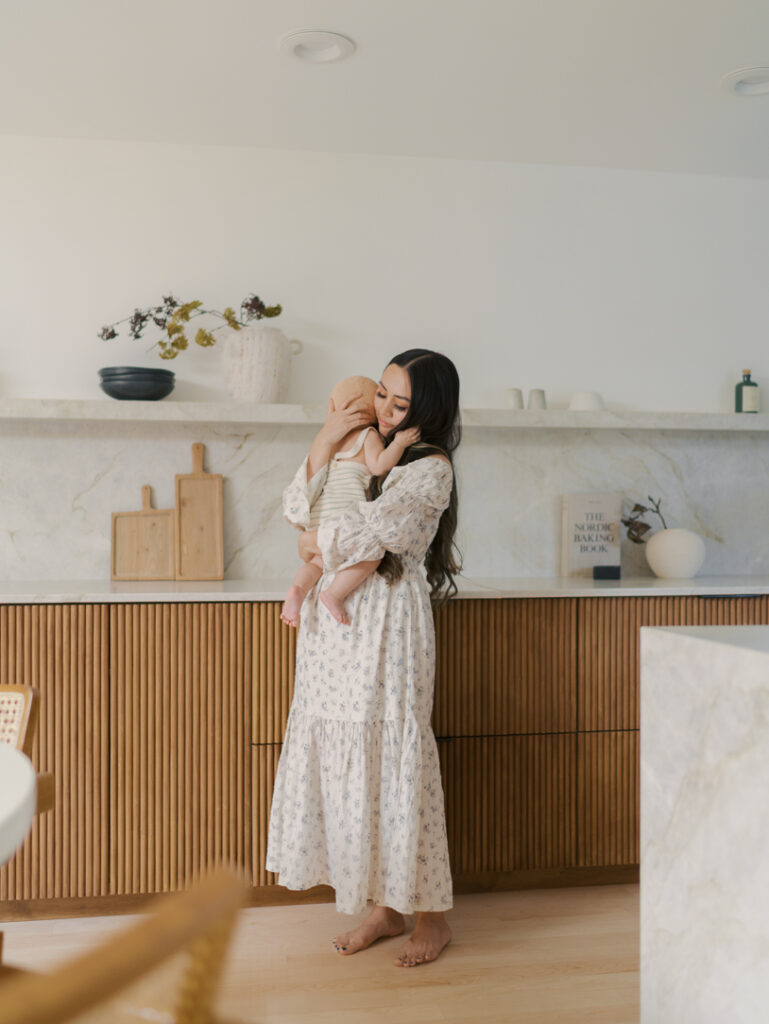 mom in kitchen holding baby close Family Photos Colorado Springs