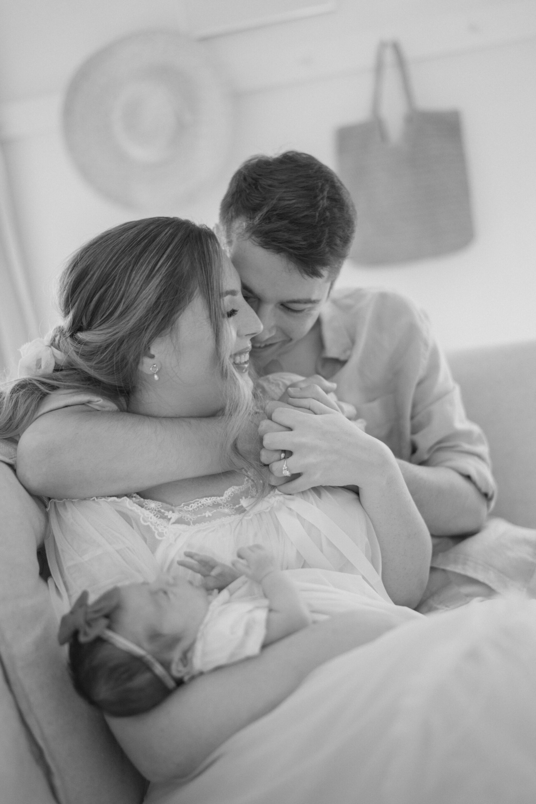 new family of three hugging by Newborn Photographer Colorado Springs Lauren Bounds