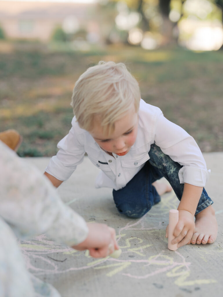 boy writing with chalk