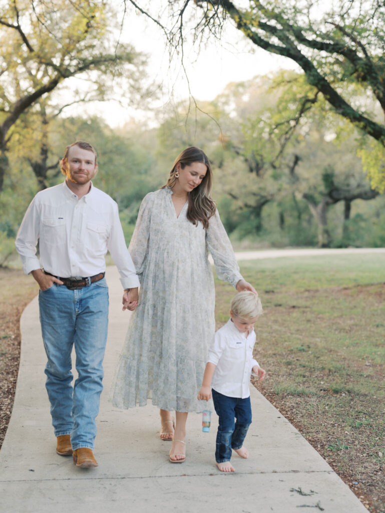 family of three walking in park