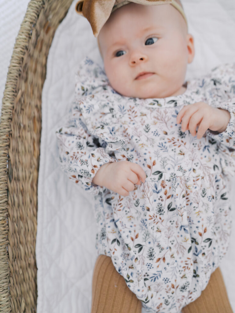 baby laying in a basket taken by colorado springs newborn photographer