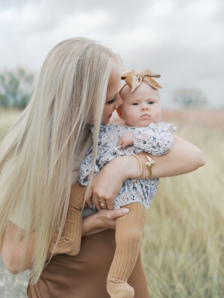 mom nuzzling young baby at Outdoor Newborn Session in Colorado Springs