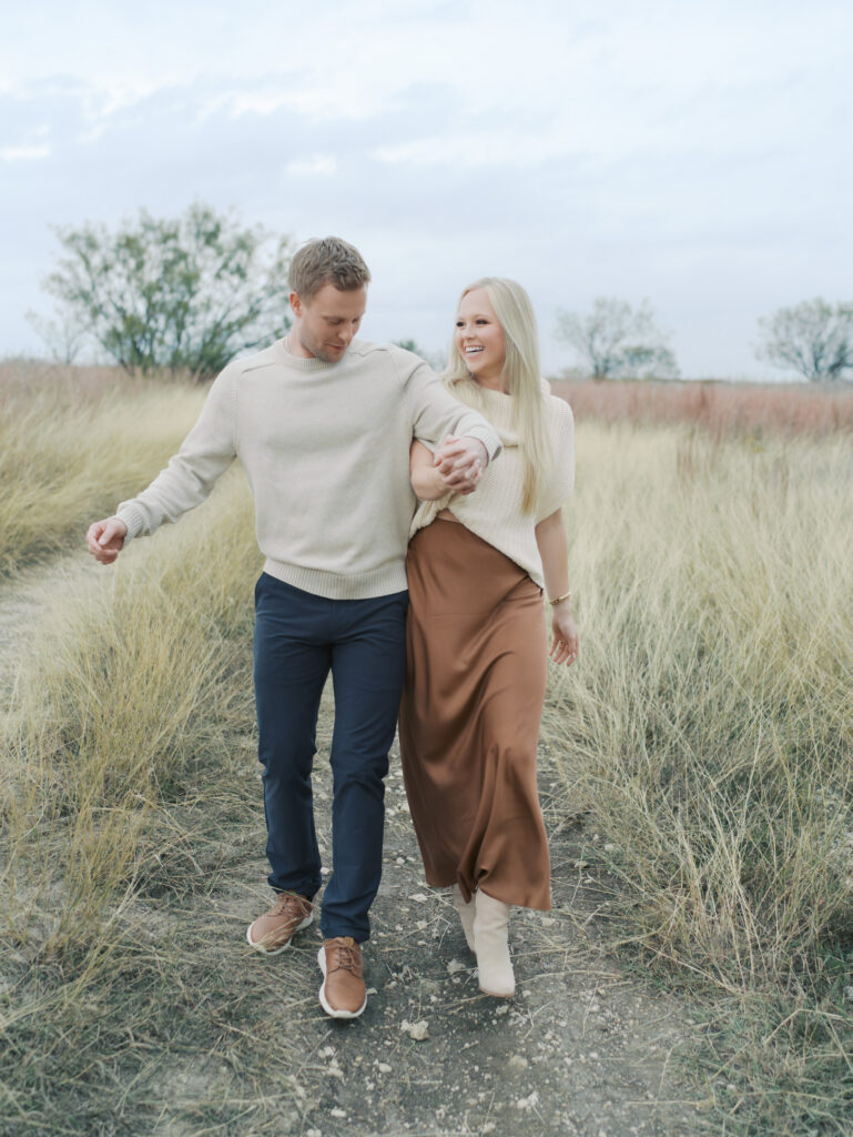 couple bumping hips and smiling by colorado springs photographer
