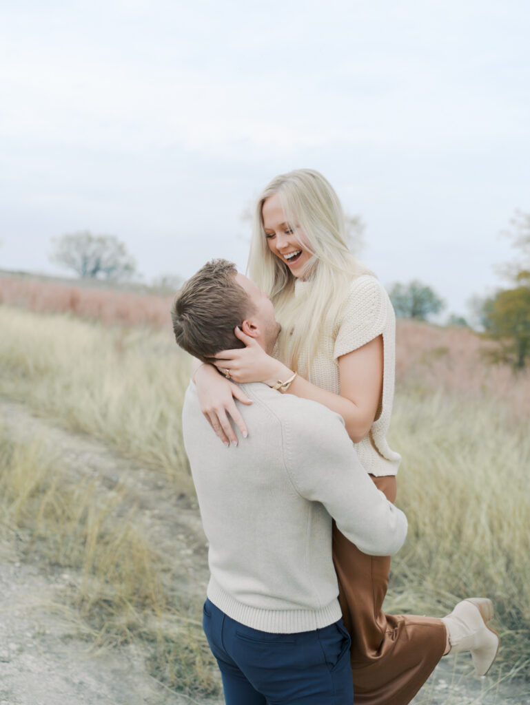 wife smiling as husband holds her by lauren bounds photography