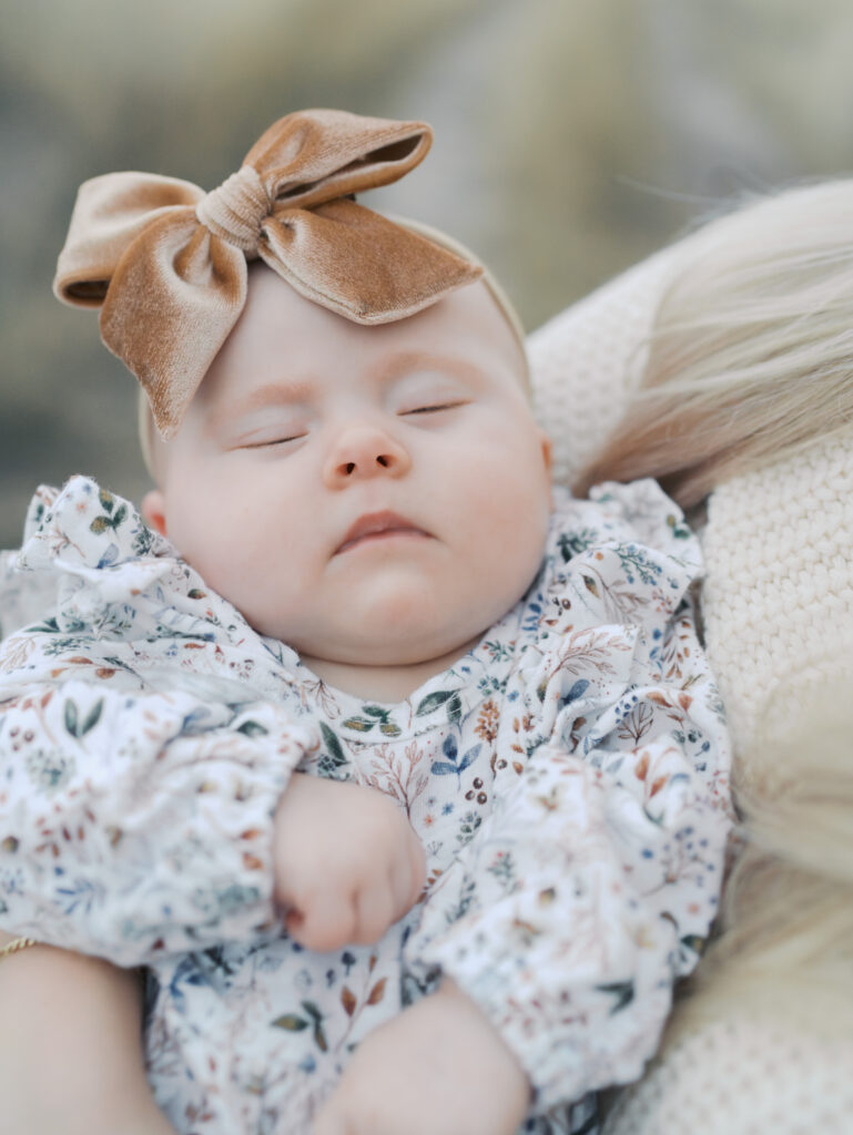 face of baby sleeping in moms arms by colorado springs newborn photographer