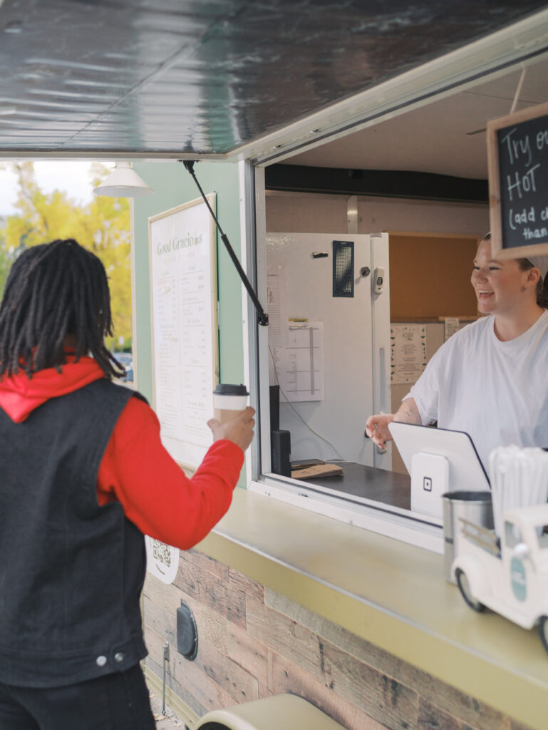 Grace smiling at a customer at the Best Coffee Colorado Springs Good Gracious Coffee Trailer