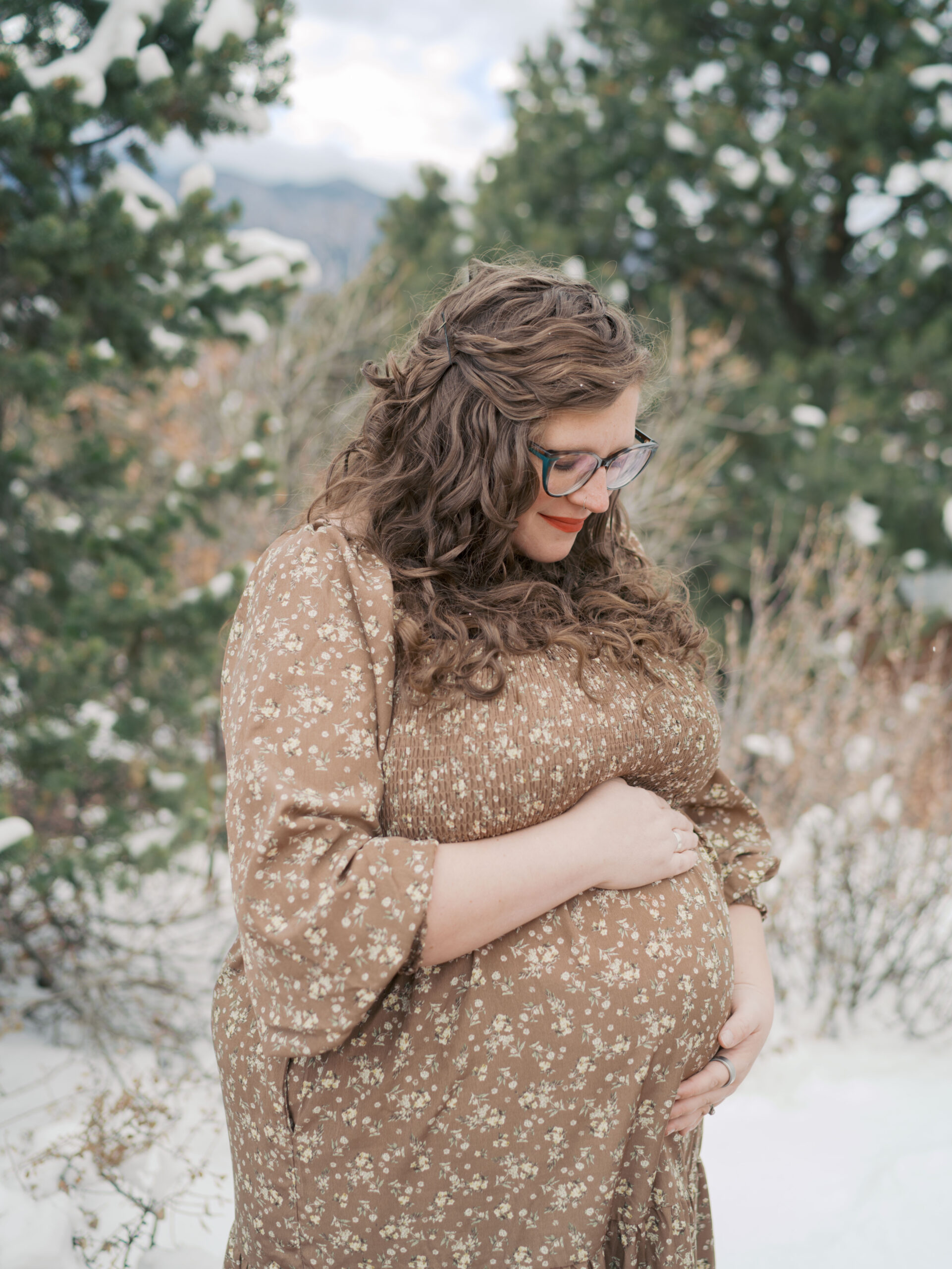 Expecting Mom gazing at belly during a Colorado Springs Maternity Session showing what to wear for maternity photos