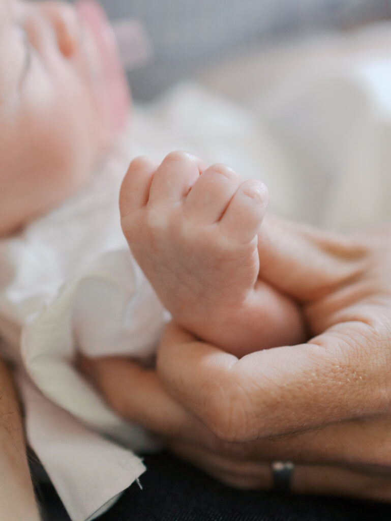 newborn hand in dad's hand