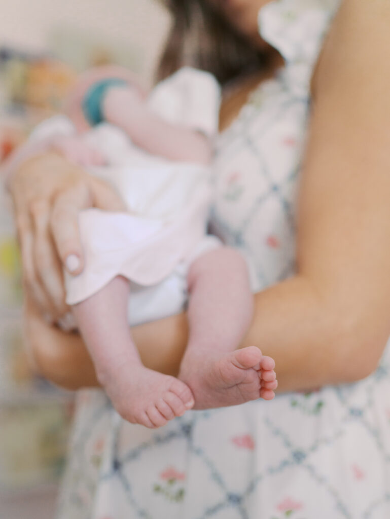 newborns feet in moms arms