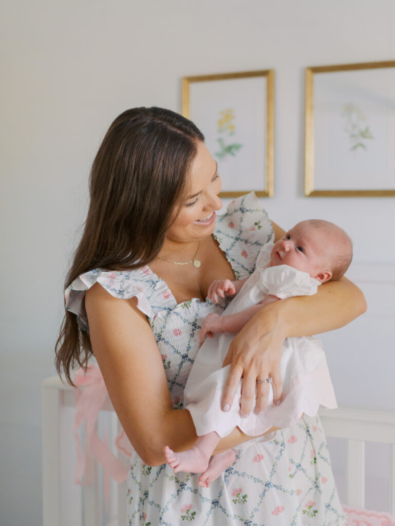 mom looking at newborn baby in arms for newborn session in colorado springs, co