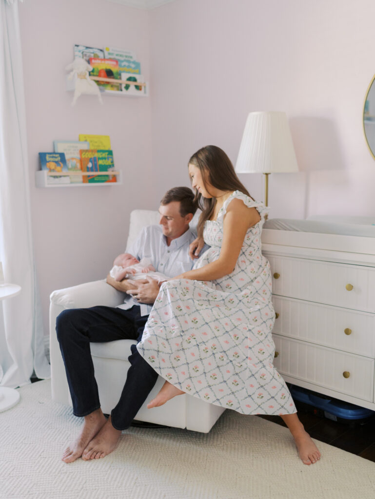 parents sitting together with newborn for newborn photos in colorado springs, co