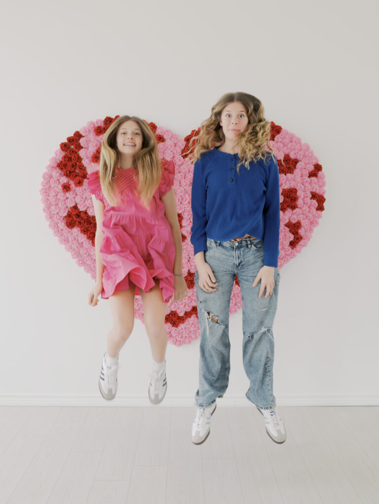 twin teen girls jumping together