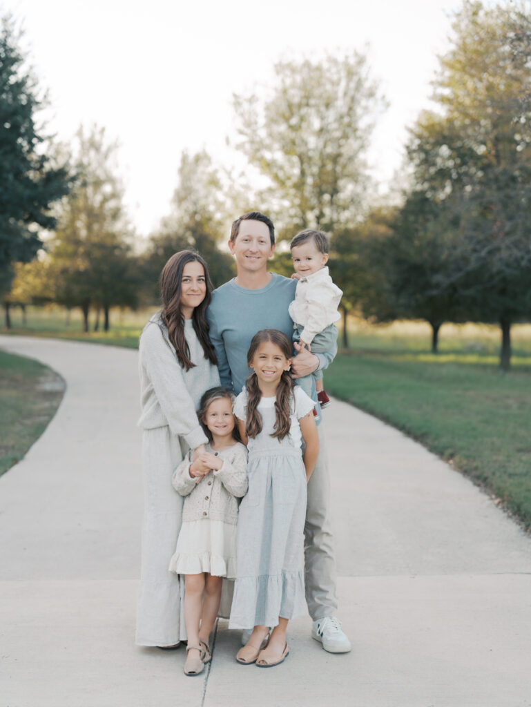 family of fives smiling for the camera at a Colorado Springs family session by Lauren Bounds Photography
