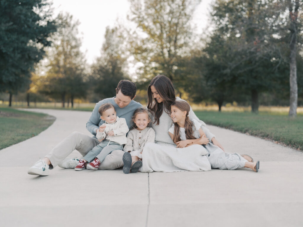 family of five sitting on sidewalk for colorado springs family session with Lauren Bounds Photography